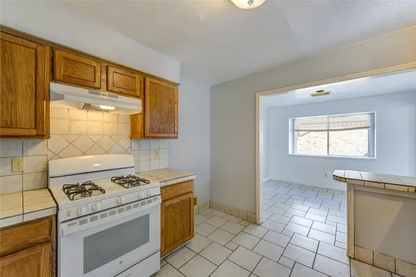 a kitchen with a stove a sink and a refrigerator