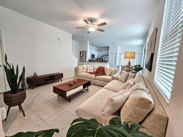 a living room with furniture and a chandelier