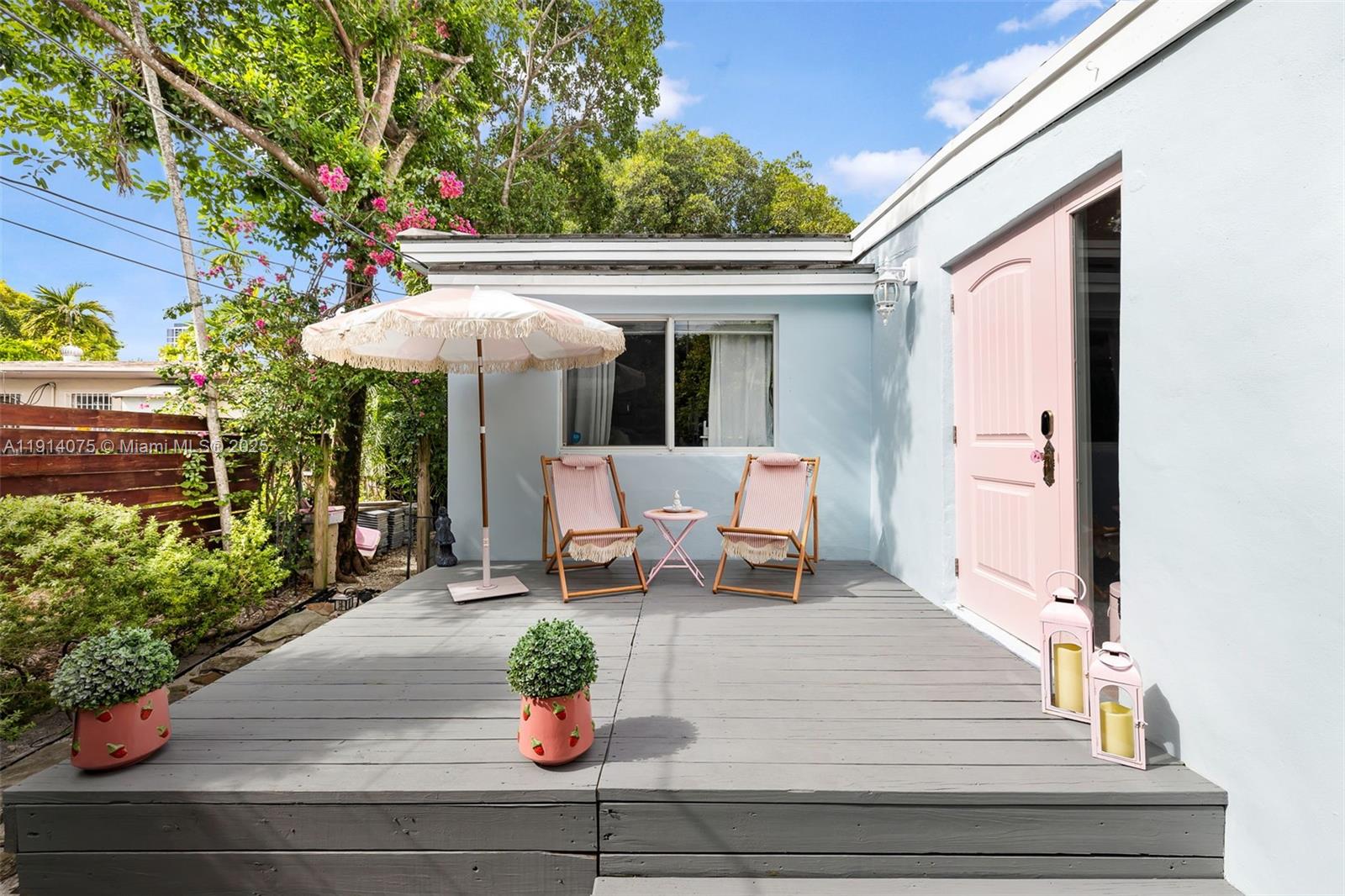 a view of a patio with table and chairs potted plants with wooden floor