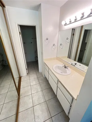 a bathroom with a sink a vanity and a mirror
