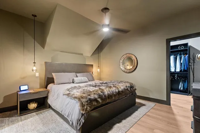 a bedroom with a large bed and a flat screen tv