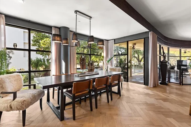 a living room with patio furniture and a large window