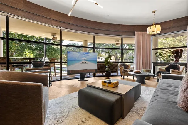 a living room with furniture a rug and a large window