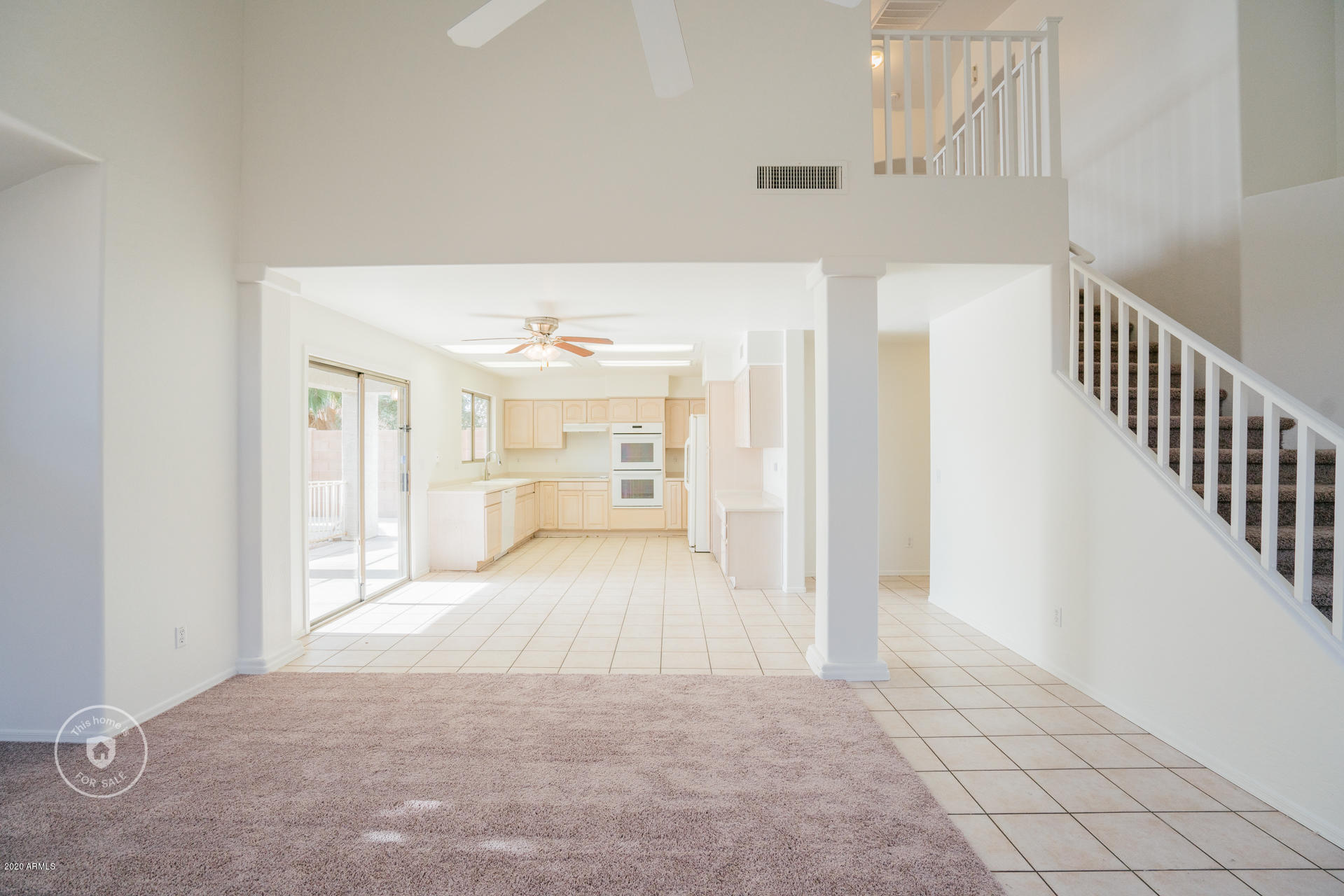 11245 West Almeria Road Avondale, AZ 85392 - Photo 11 of 23 a view of a hallway with wooden floor and cabinet