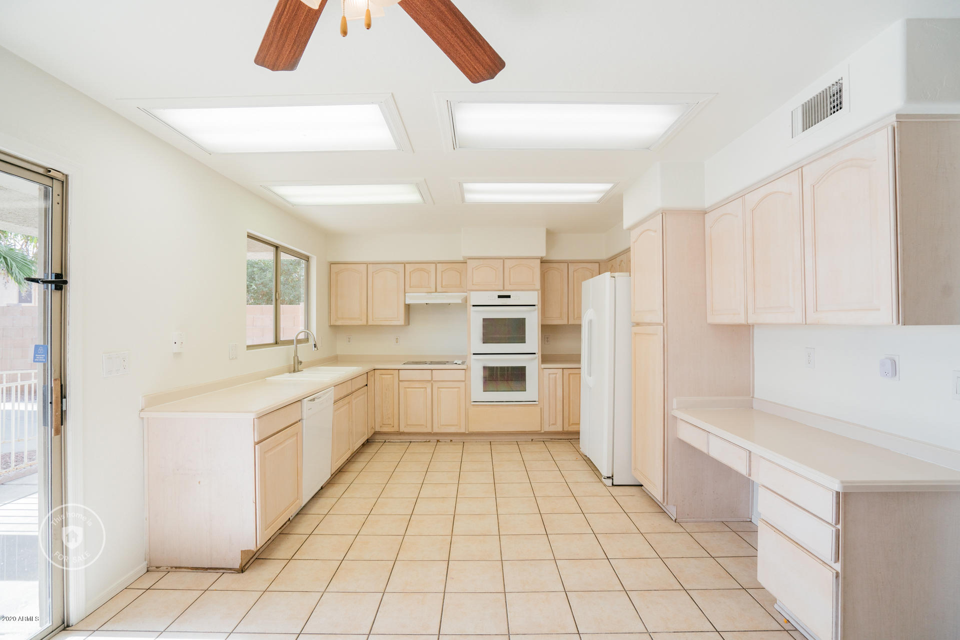 11245 West Almeria Road Avondale, AZ 85392 - Photo 3 of 23 a large white kitchen with a stove a sink dishwasher and a refrigerator