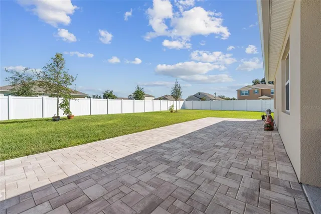 a view of a swimming pool with a yard