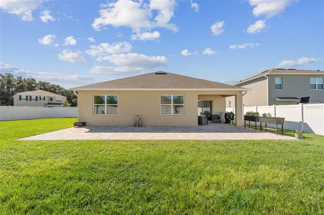 a view of a house with a yard and sitting area