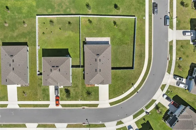 an aerial view of a residential houses with outdoor space