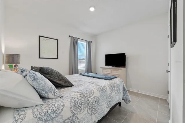 a bedroom with a bed and a television