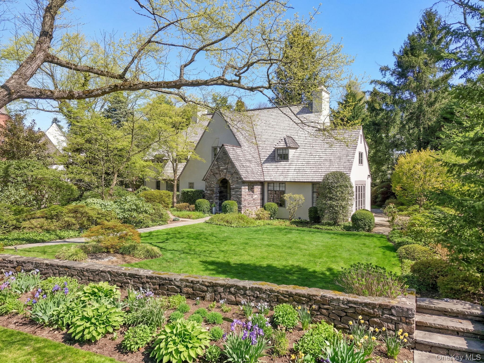 4 High Road Bronxville, NY 10708 - Photo 1 of 32 a front view of a house with a garden