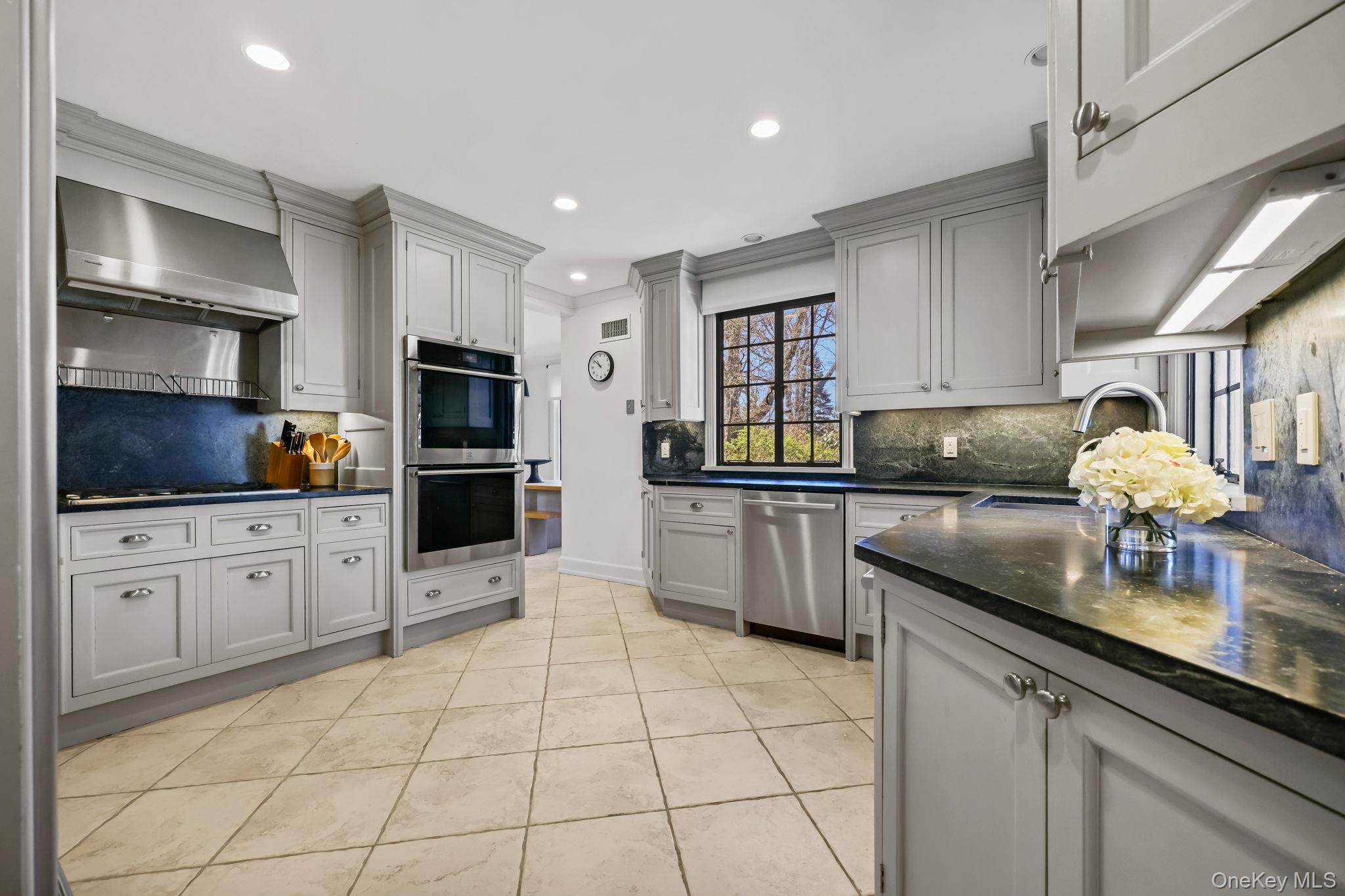 4 High Road Bronxville, NY 10708 - Photo 16 of 32 a kitchen with stainless steel appliances a sink dishwasher stove refrigerator and cabinets