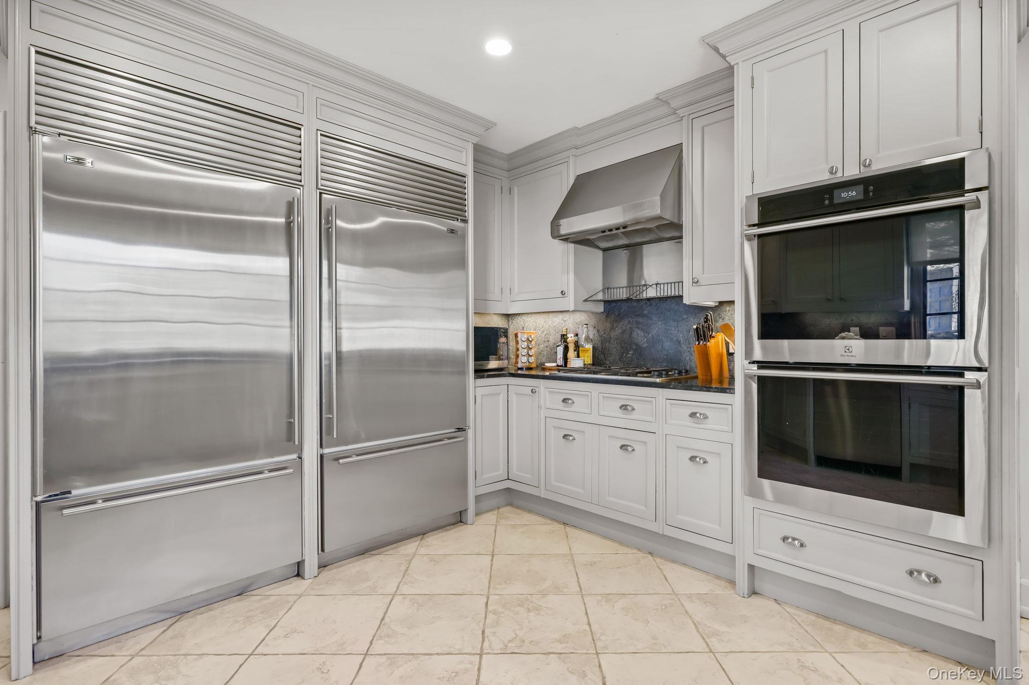 4 High Road Bronxville, NY 10708 - Photo 18 of 32 a kitchen with white cabinets and appliances