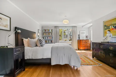 a spacious bedroom with a bed and a dresser