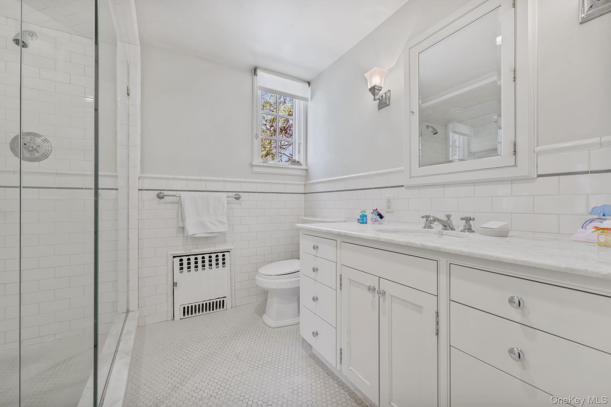 4 High Road Bronxville, NY 10708 - Photo 25 of 32 a bathroom with a toilet sink and mirror