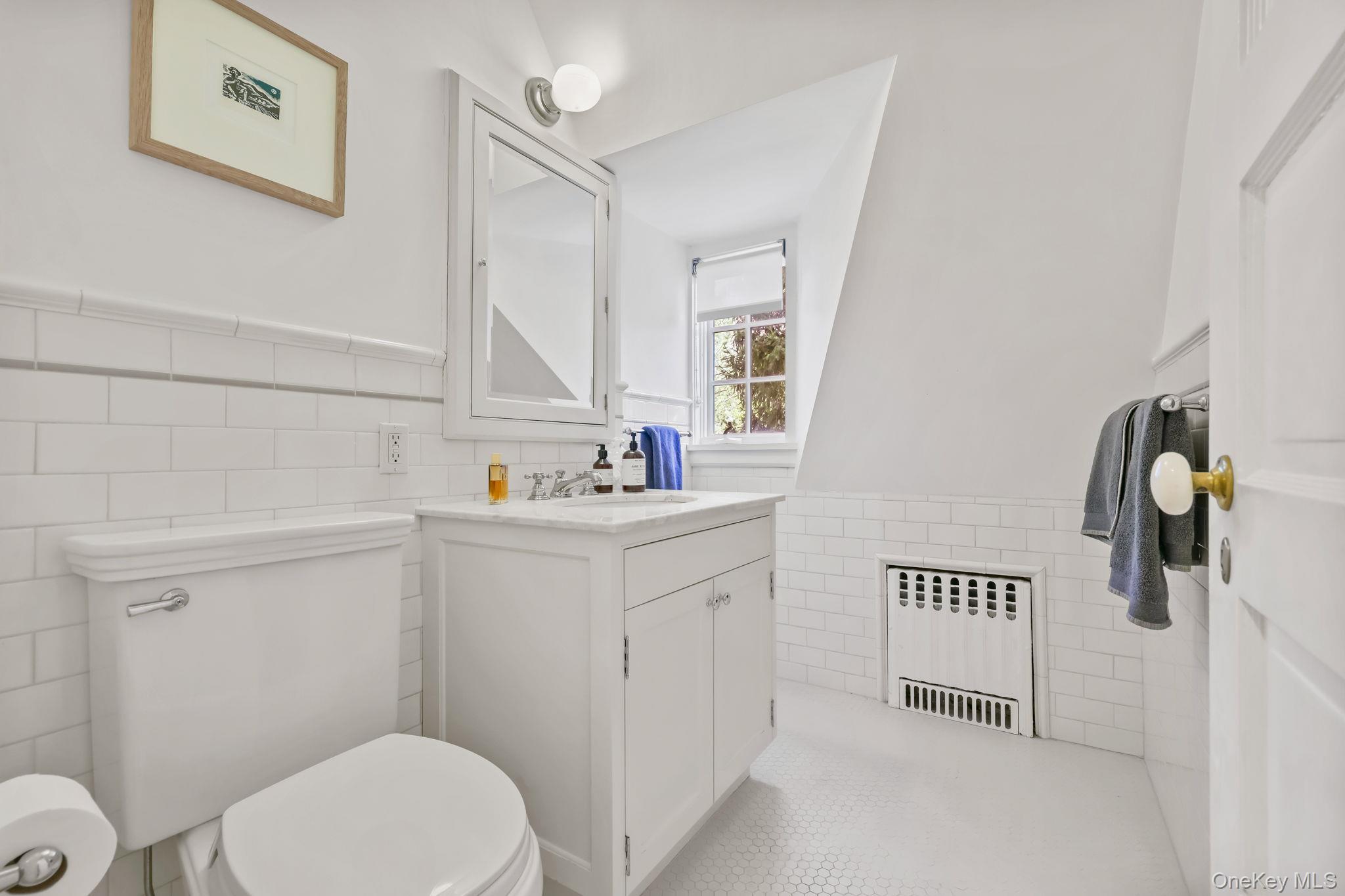 4 High Road Bronxville, NY 10708 - Photo 27 of 32 a bathroom with a sink mirror vanity and toilet