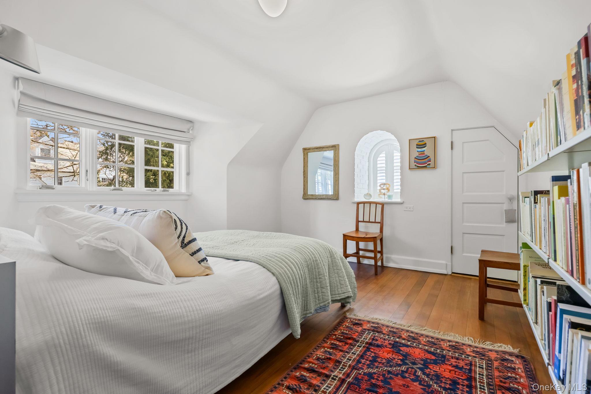4 High Road Bronxville, NY 10708 - Photo 28 of 32 a spacious bedroom with a bed a dresser and wooden floor