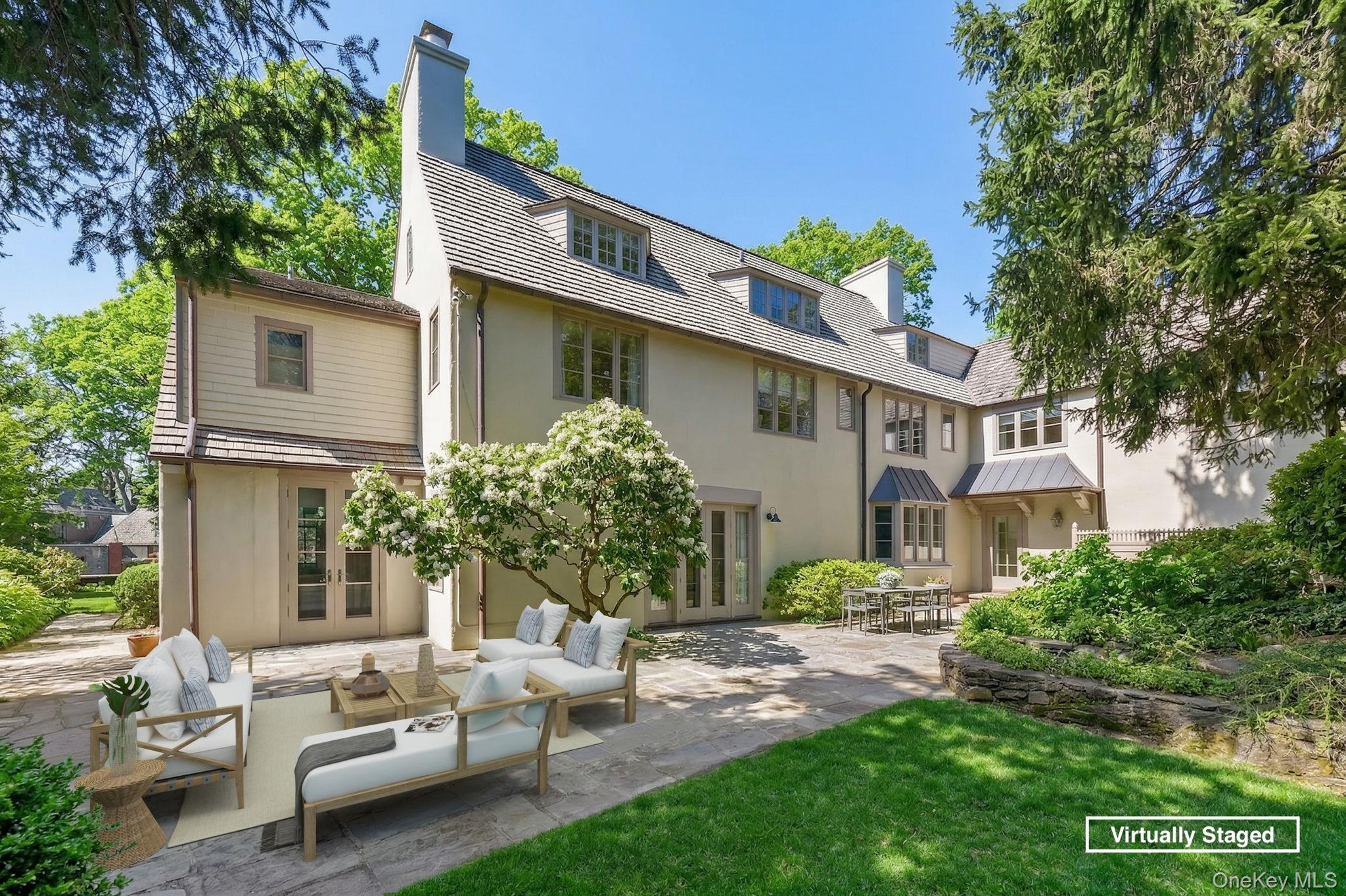 4 High Road Bronxville, NY 10708 - Photo 30 of 32 a view of a white house with a chairs in a patio