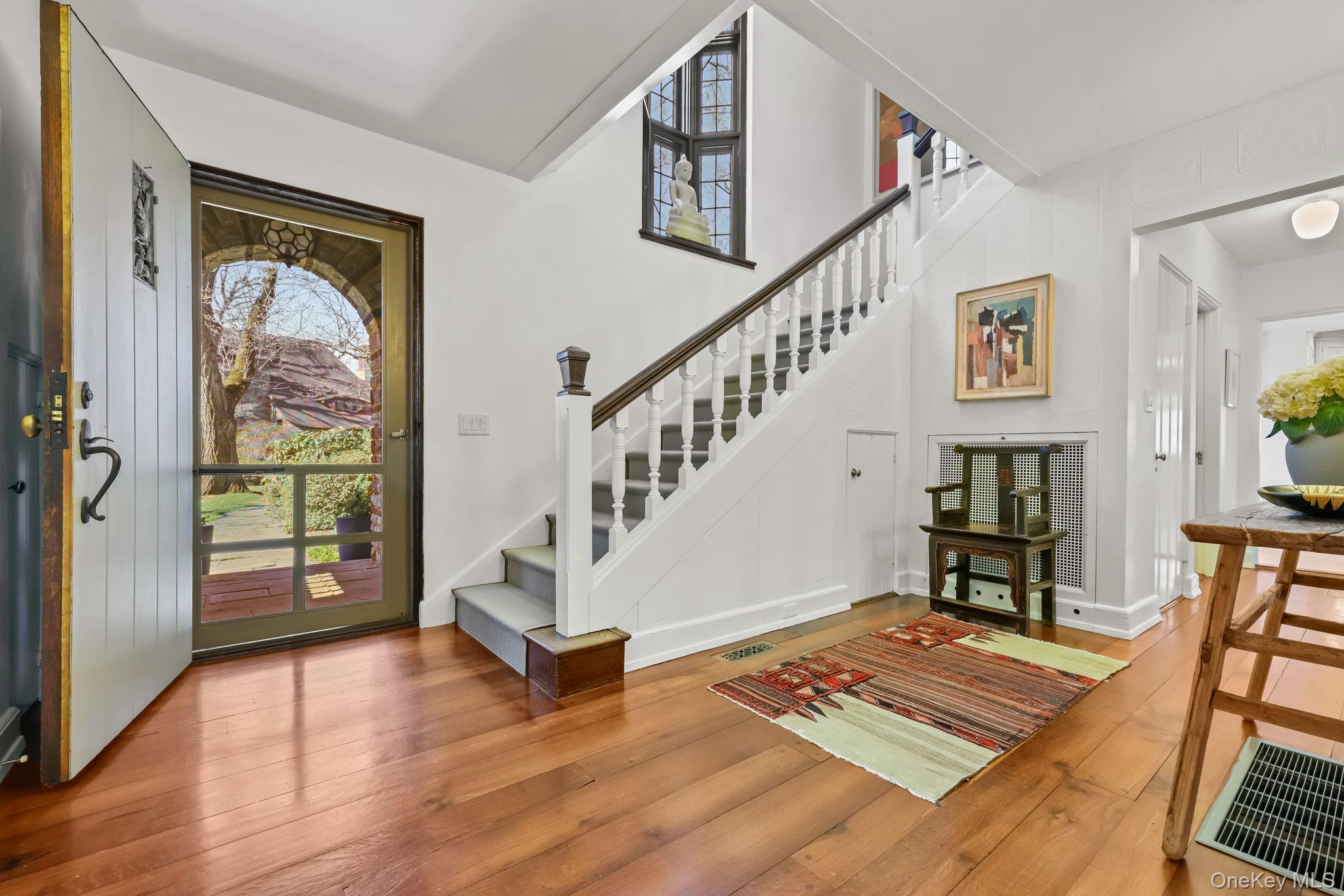 4 High Road Bronxville, NY 10708 - Photo 3 of 32 a view of an entryway with wooden floor windows a fireplace and a way to kitchen
