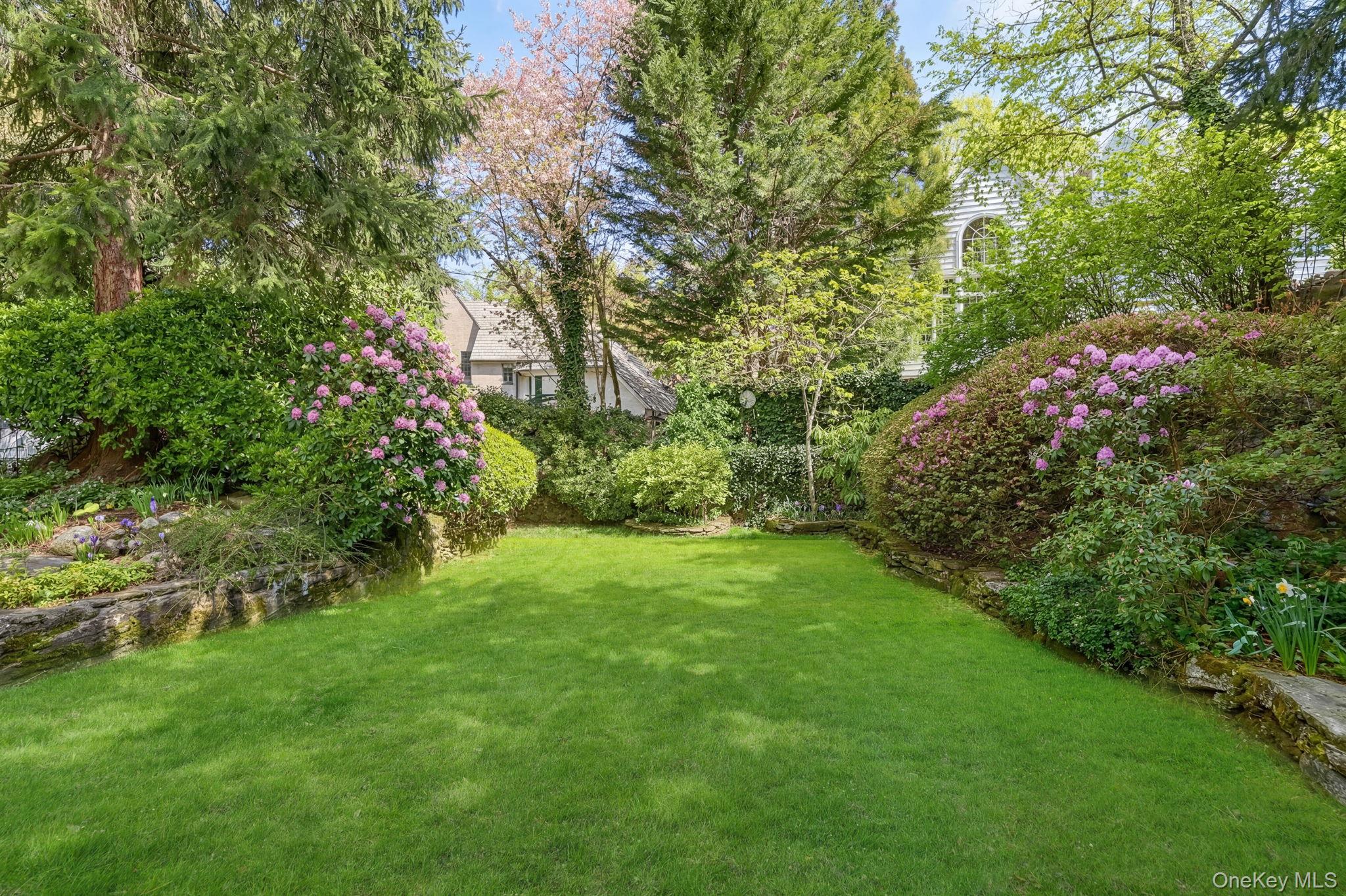 4 High Road Bronxville, NY 10708 - Photo 32 of 32 a view of a yard with plants and large trees