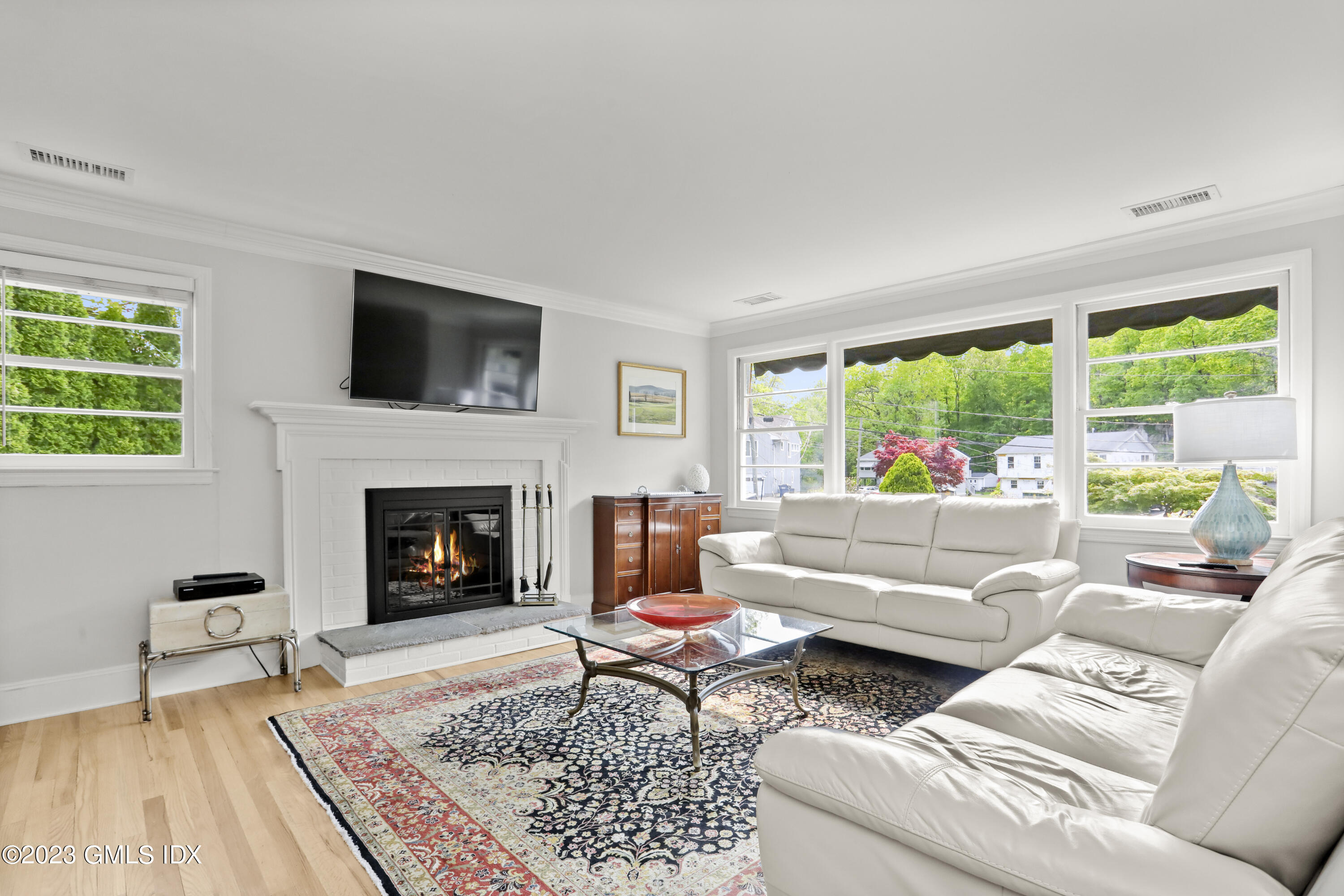 17 Fado Lane Cos Cob, CT 06807 - Photo 3 of 16 a living room with furniture a flat screen tv and a fireplace