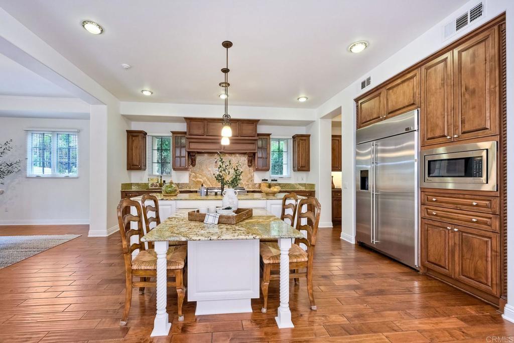 17284 Reflections Circle San Diego, CA 92127 - Photo 14 of 53 a view of a dining room with furniture window and wooden floor