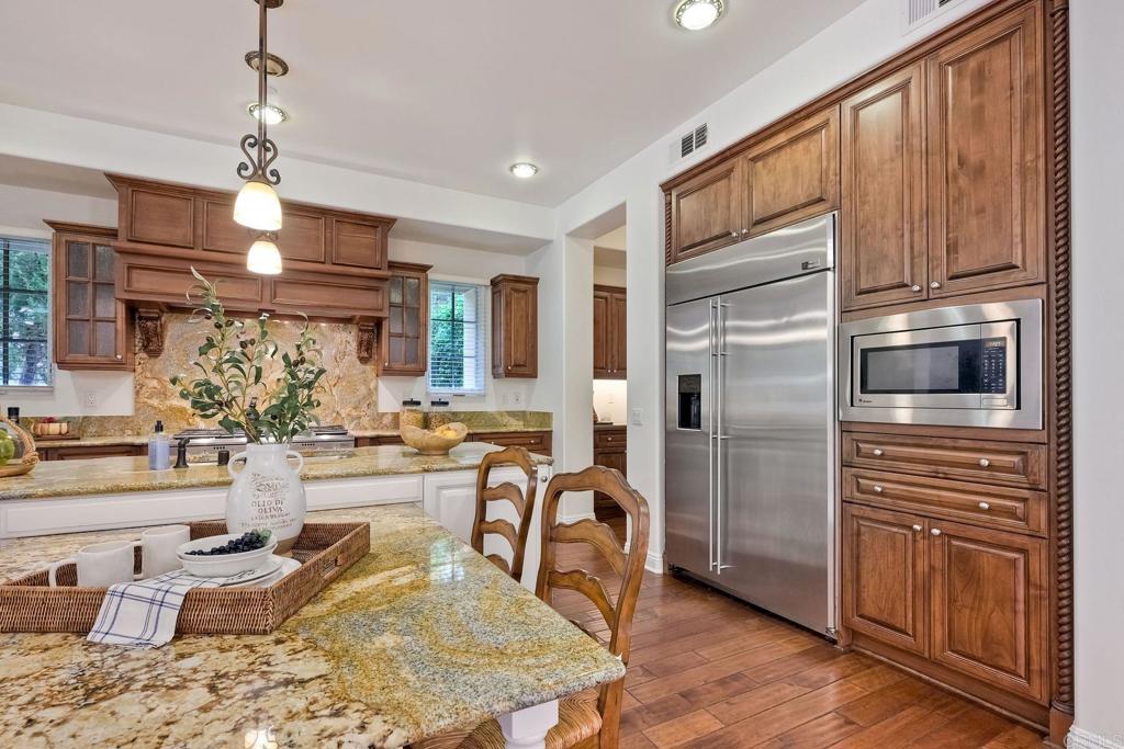 17284 Reflections Circle San Diego, CA 92127 - Photo 15 of 53 a kitchen with stainless steel appliances granite countertop a refrigerator a stove and a sink with cabinets