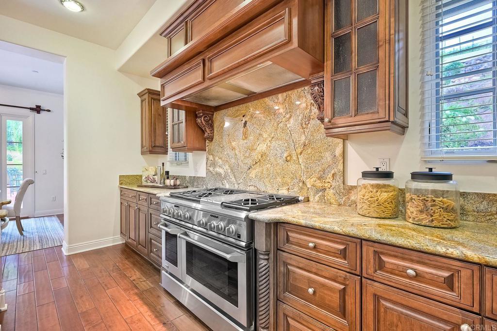 17284 Reflections Circle San Diego, CA 92127 - Photo 17 of 53 a kitchen with stainless steel appliances granite countertop a stove and a sink