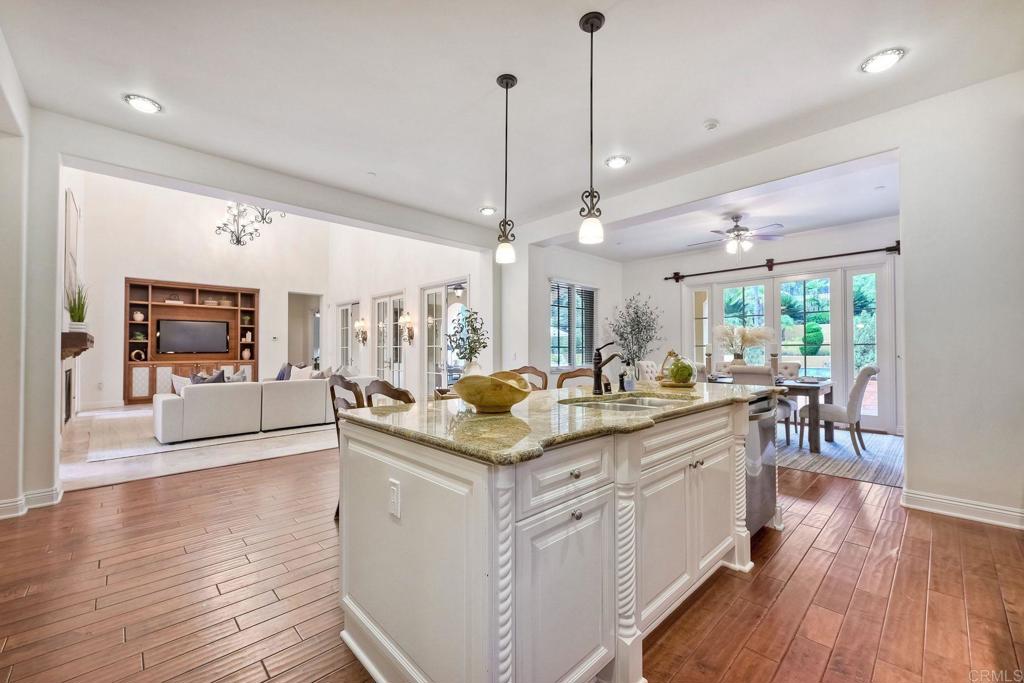 17284 Reflections Circle San Diego, CA 92127 - Photo 18 of 53 a kitchen with stainless steel appliances granite countertop a lot of counter space and wooden floors