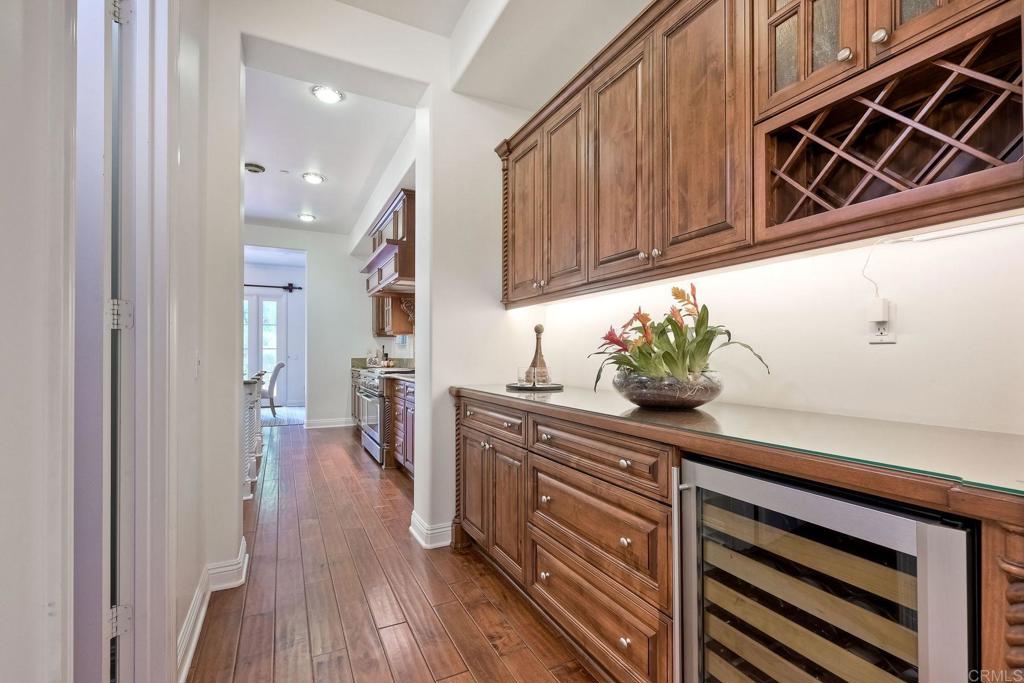 17284 Reflections Circle San Diego, CA 92127 - Photo 19 of 53 a kitchen with stainless steel appliances granite countertop a coffee maker on wooden floors and cabinets