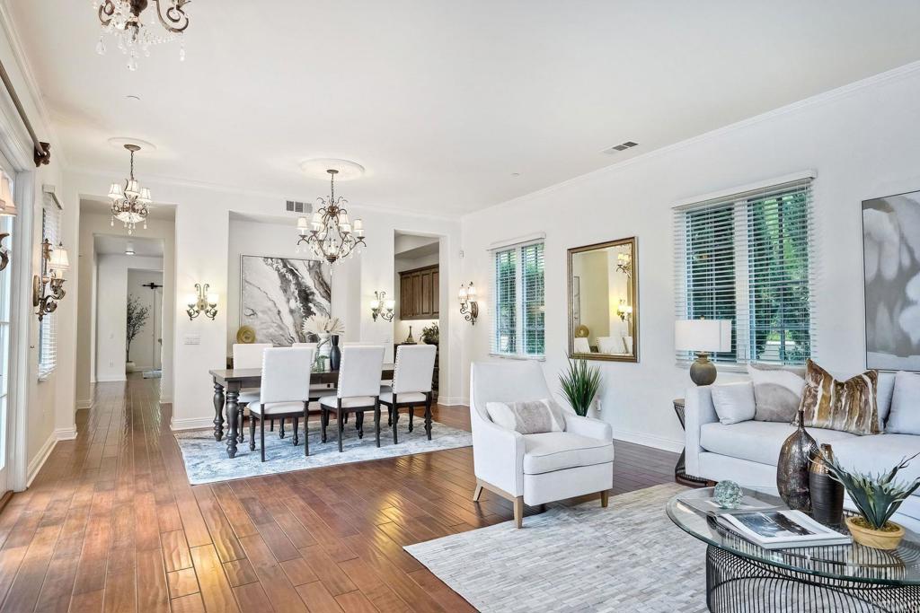 17284 Reflections Circle San Diego, CA 92127 - Photo 28 of 53 a living room with furniture wooden floor and a chandelier