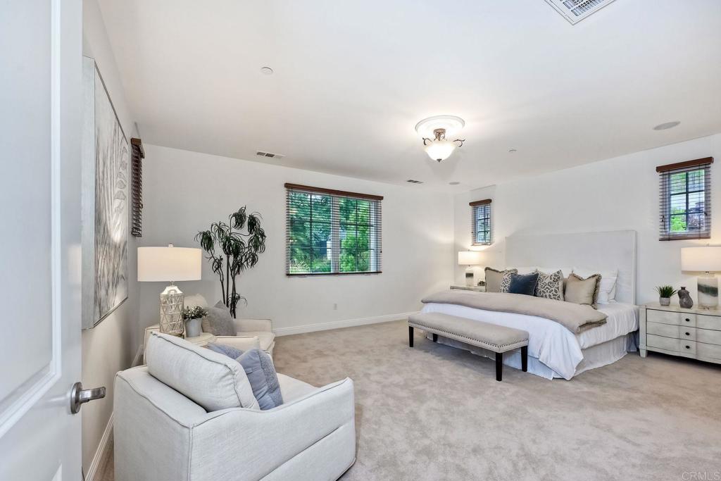17284 Reflections Circle San Diego, CA 92127 - Photo 35 of 53 a spacious bedroom with a bed and a couch