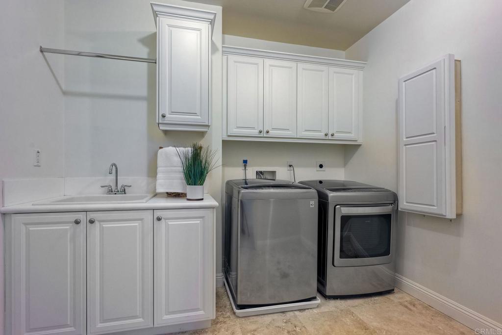 17284 Reflections Circle San Diego, CA 92127 - Photo 38 of 53 a kitchen with granite countertop white cabinets and stainless steel appliances
