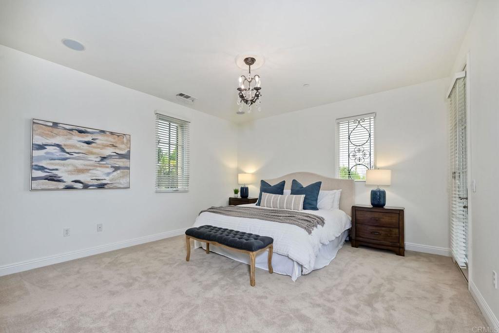 17284 Reflections Circle San Diego, CA 92127 - Photo 39 of 53 a bedroom with a bed and a painting on the wall