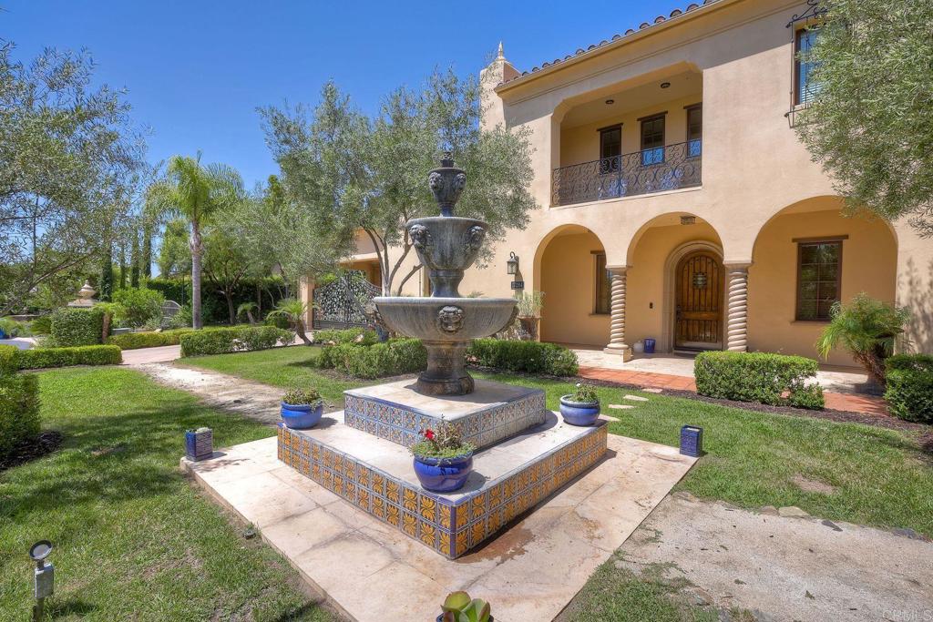 17284 Reflections Circle San Diego, CA 92127 - Photo 4 of 53 a front view of a house with garden and trees