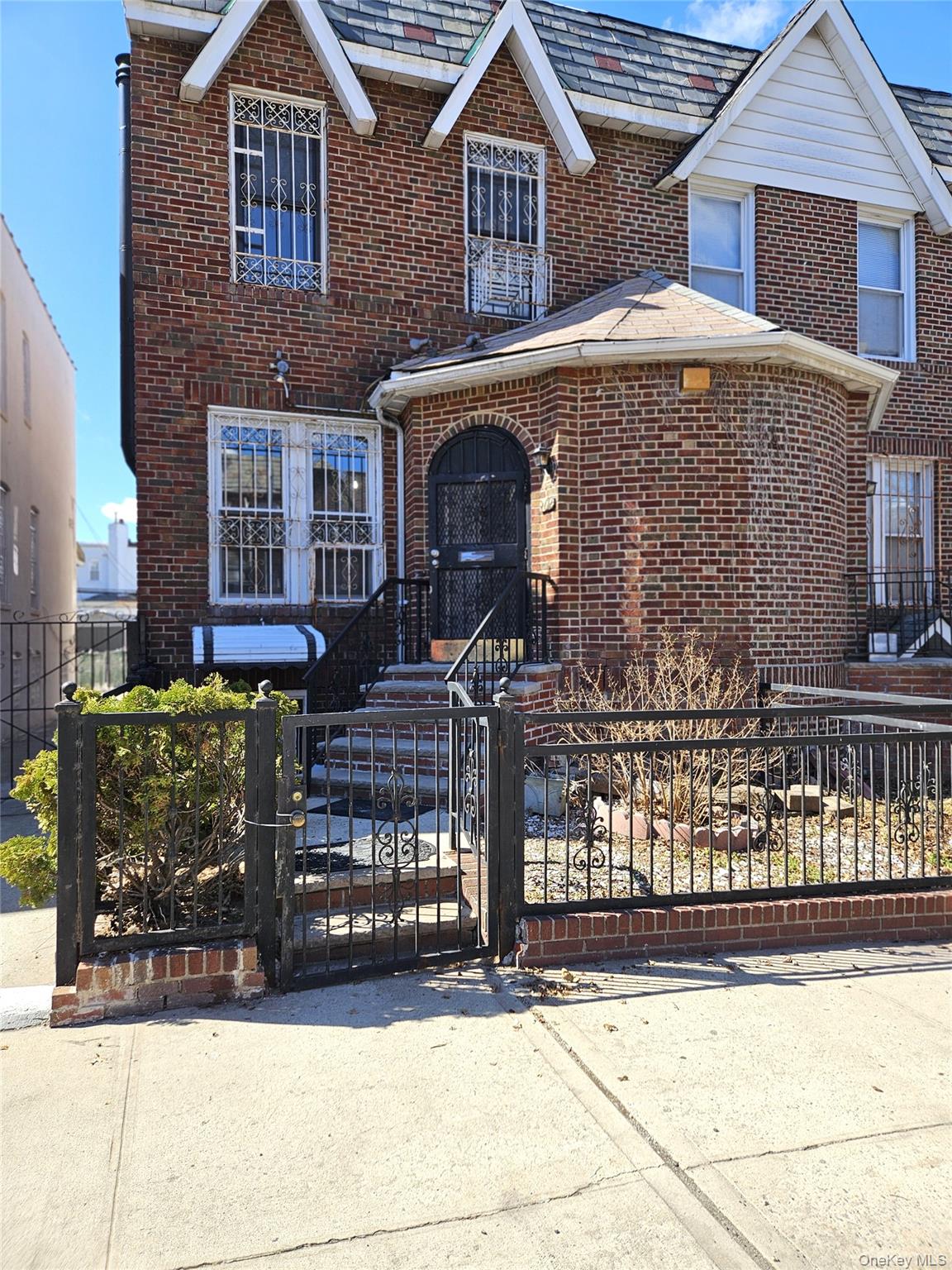 30-32 84th Street Queens, NY 11370 - Photo 1 of 37 a front view of a house with yard