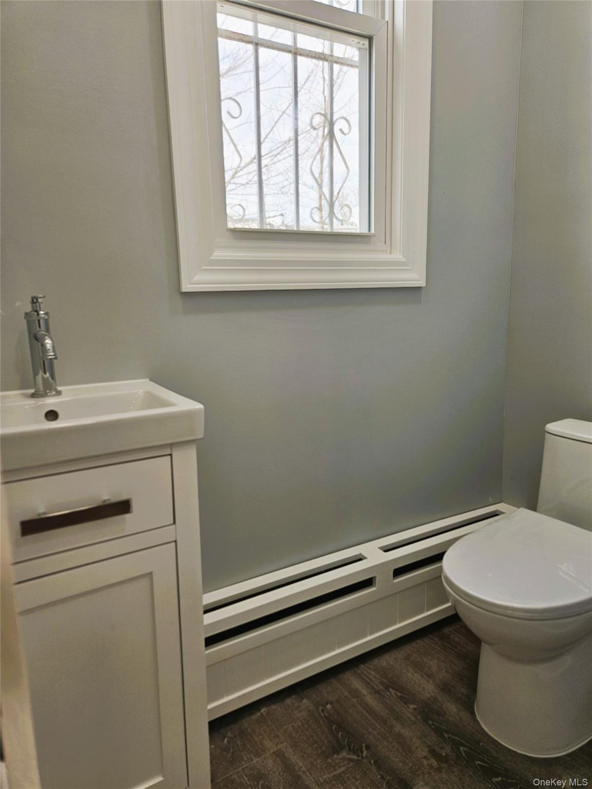30-32 84th Street Queens, NY 11370 - Photo 15 of 37 a bathroom with a toilet sink and window