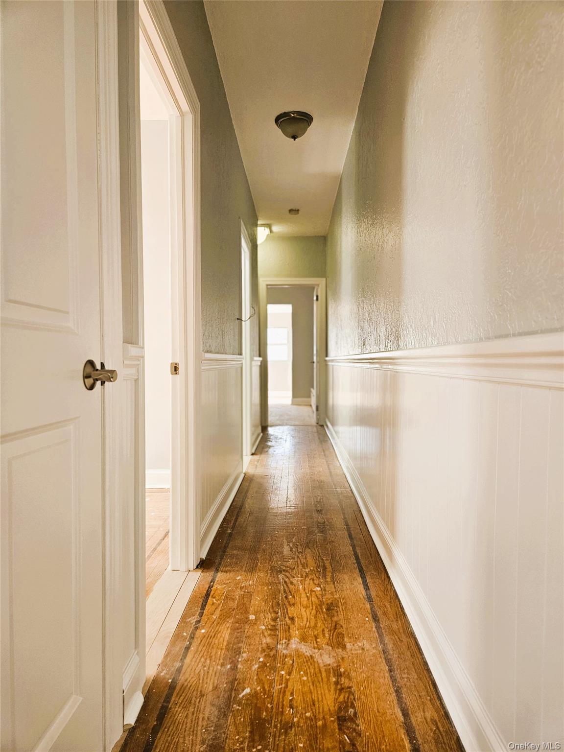 30-32 84th Street Queens, NY 11370 - Photo 18 of 37 a view of a hallway with wooden floor and a bathroom