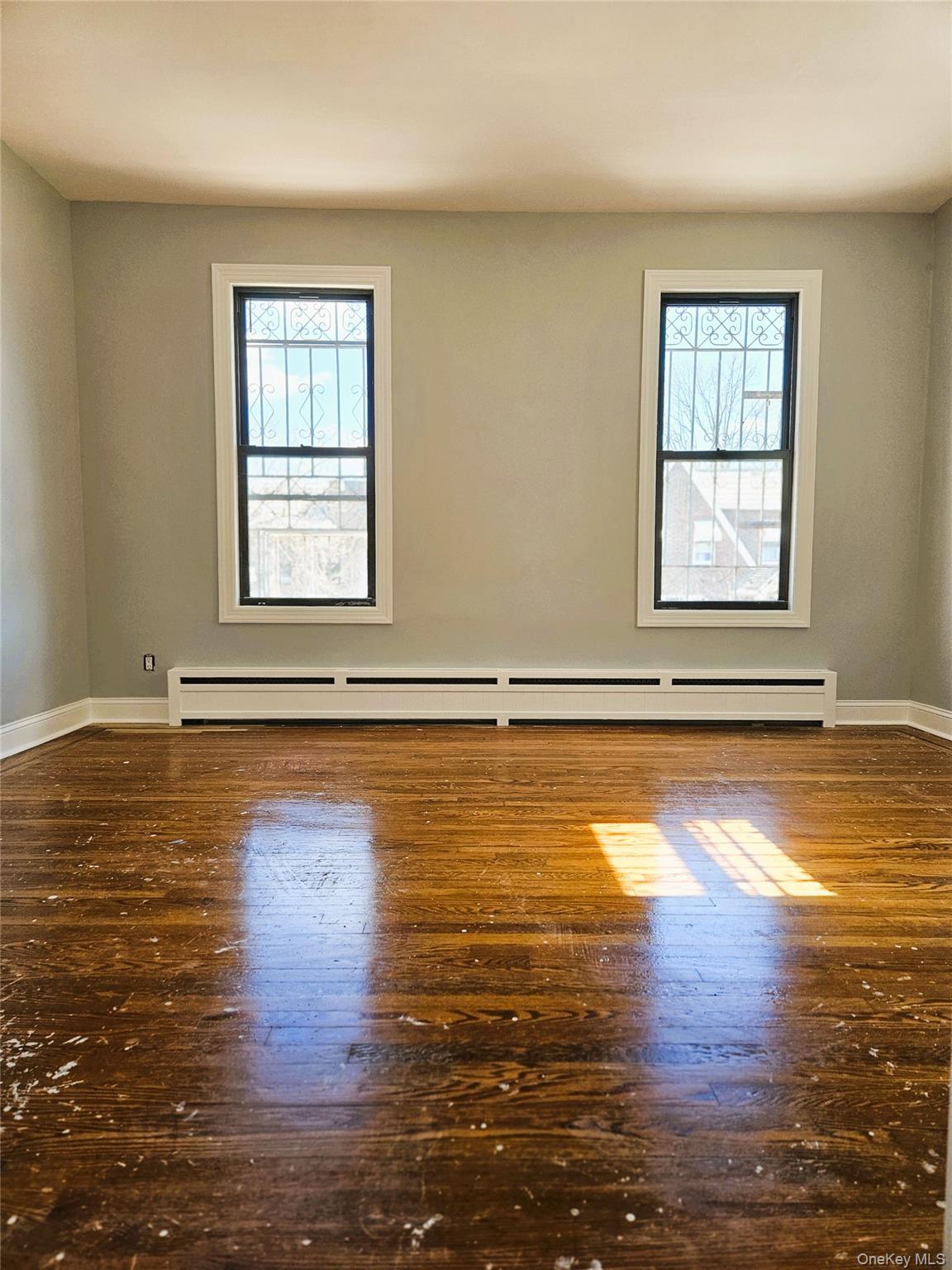 30-32 84th Street Queens, NY 11370 - Photo 19 of 37 a view of a room with wooden floor and a window
