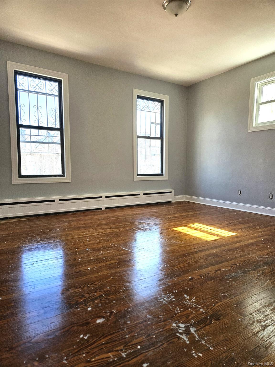 30-32 84th Street Queens, NY 11370 - Photo 20 of 37 a view of empty room with wooden floor and fan