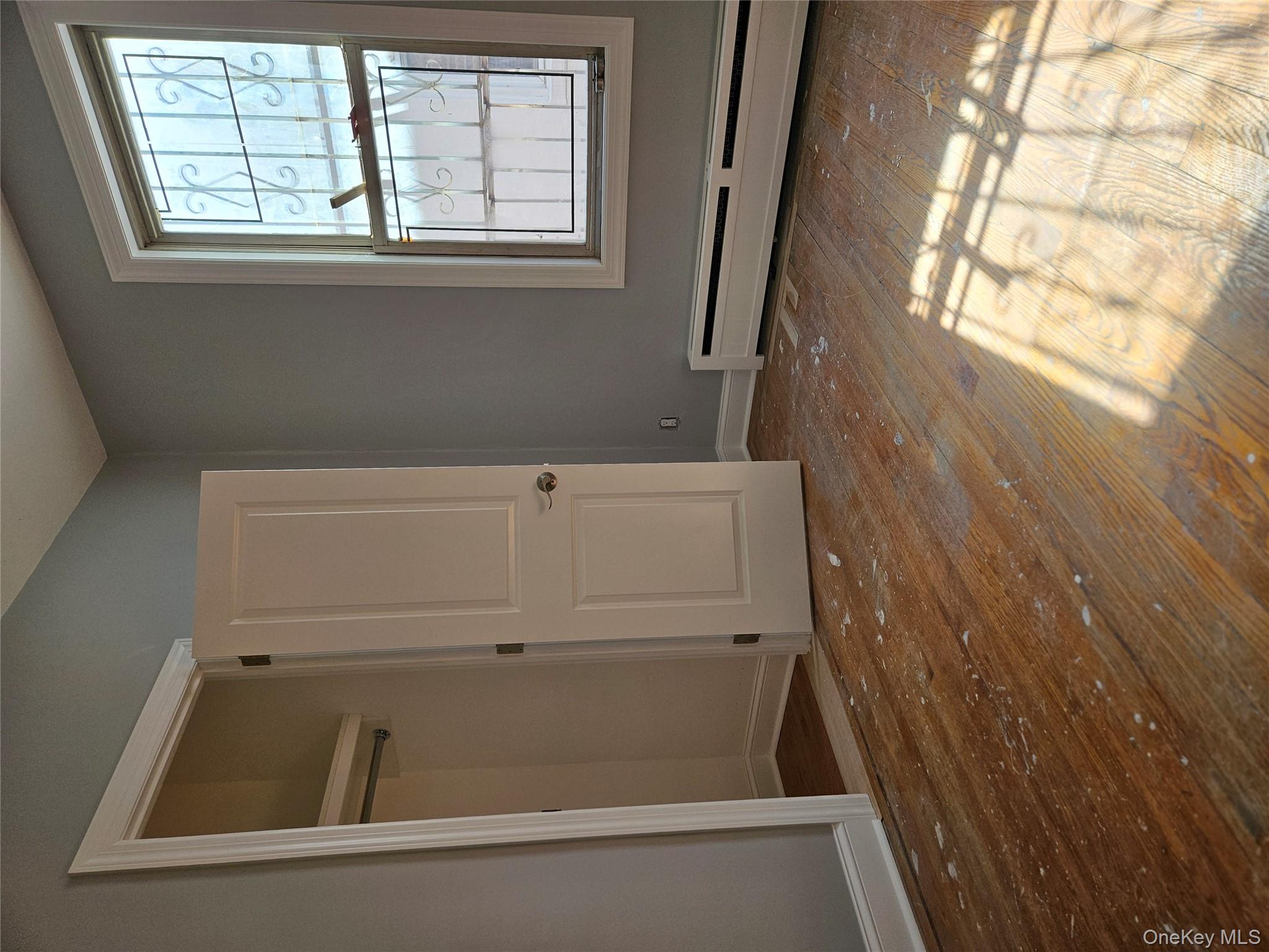 30-32 84th Street Queens, NY 11370 - Photo 23 of 37 a view of a room with wooden floor and windows