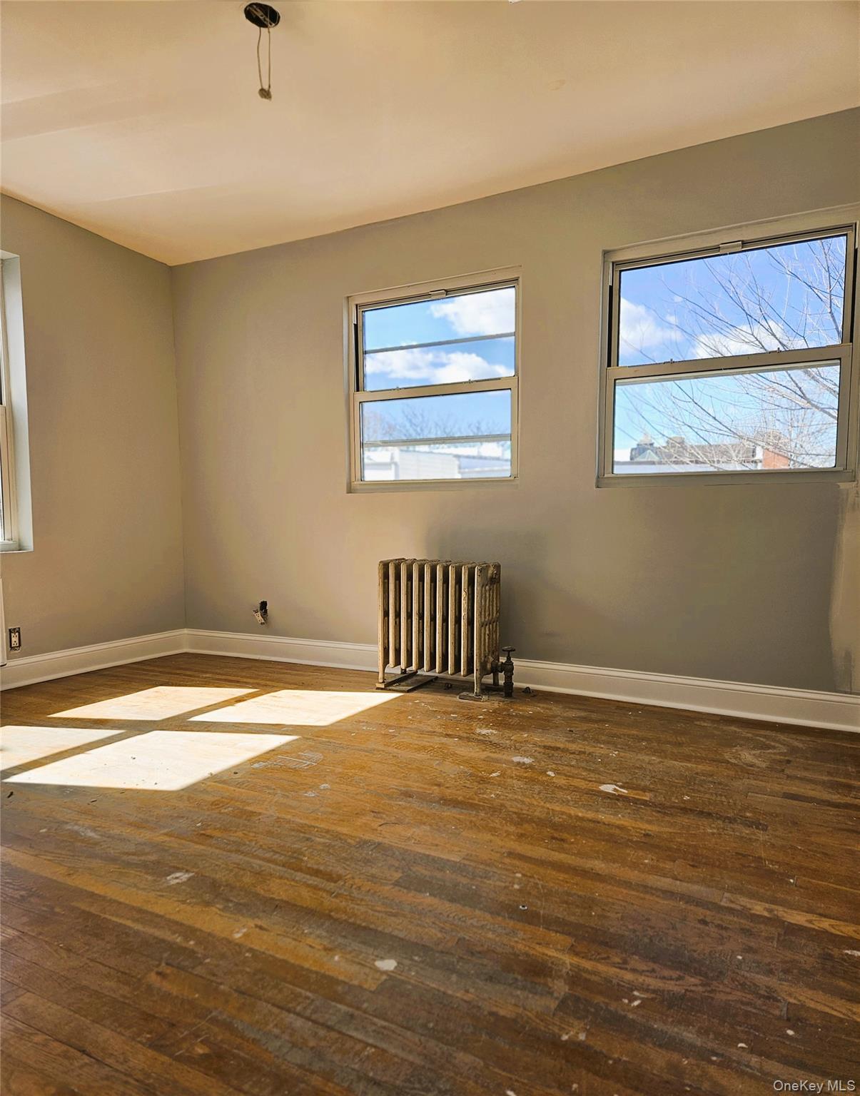 30-32 84th Street Queens, NY 11370 - Photo 26 of 37 a view of an empty room with window and wooden floor