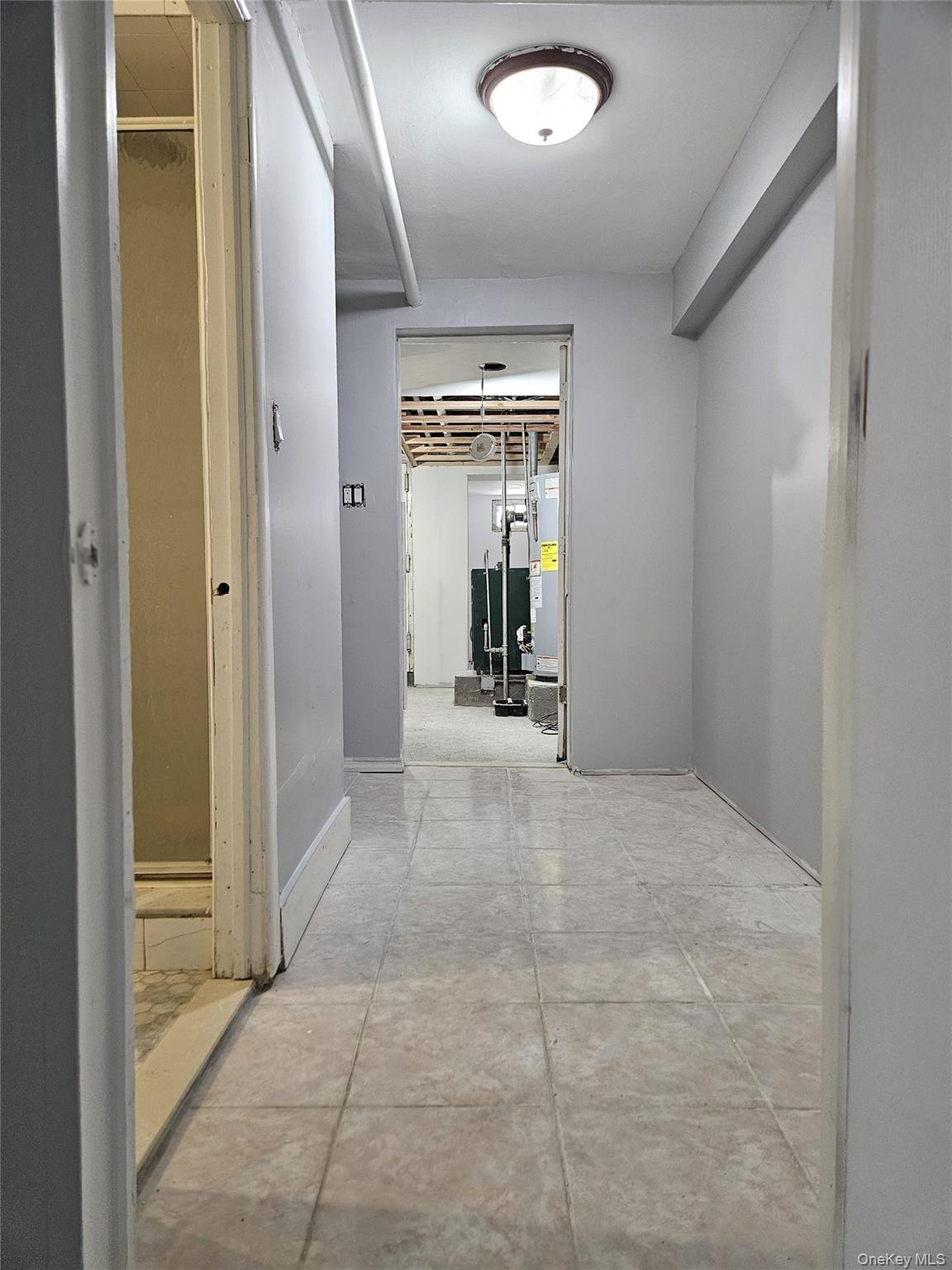 30-32 84th Street Queens, NY 11370 - Photo 33 of 37 a view of a hallway with wooden shelves