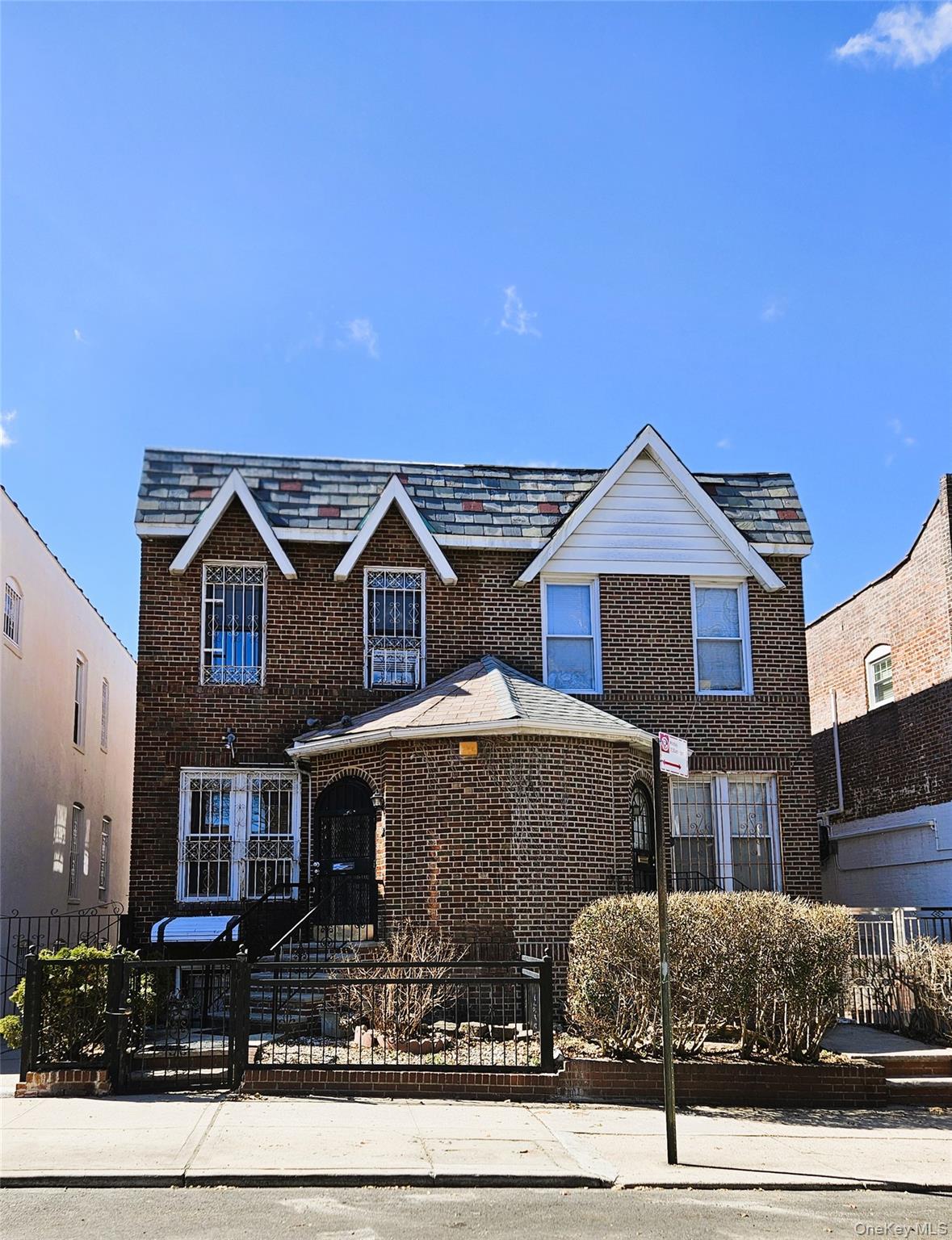 30-32 84th Street Queens, NY 11370 - Photo 37 of 37 a front view of a house with garden