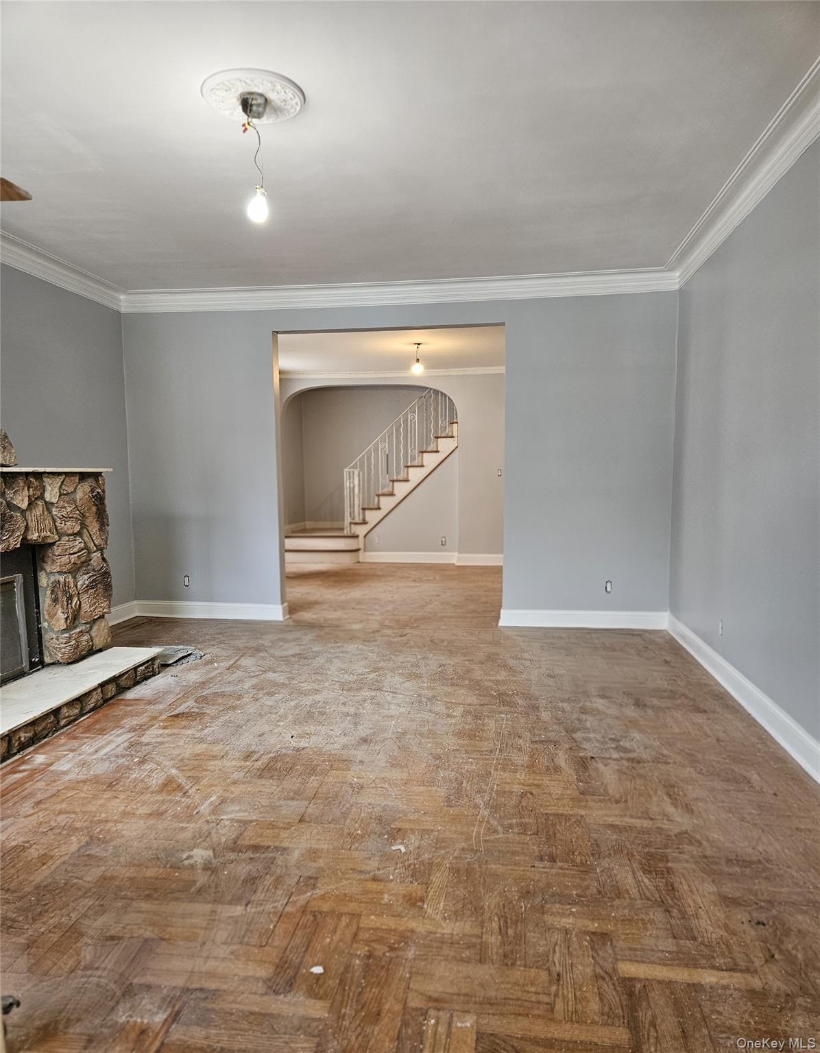 30-32 84th Street Queens, NY 11370 - Photo 4 of 37 an empty room with a fireplace and wooden floor