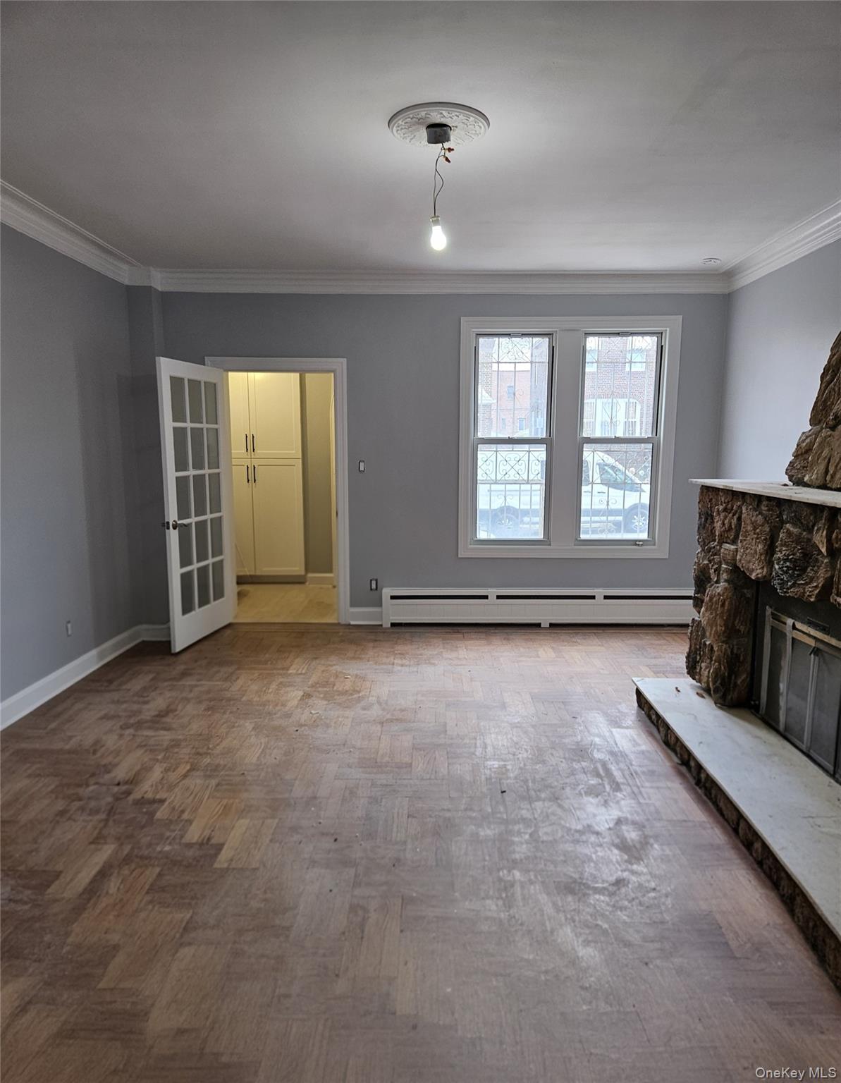 30-32 84th Street Queens, NY 11370 - Photo 5 of 37 an empty room with fireplace and windows
