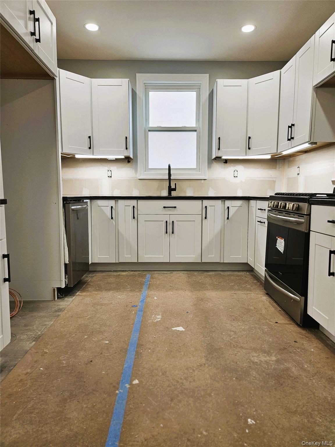 30-32 84th Street Queens, NY 11370 - Photo 8 of 37 a kitchen with stainless steel appliances granite countertop a stove a sink and a granite counter tops