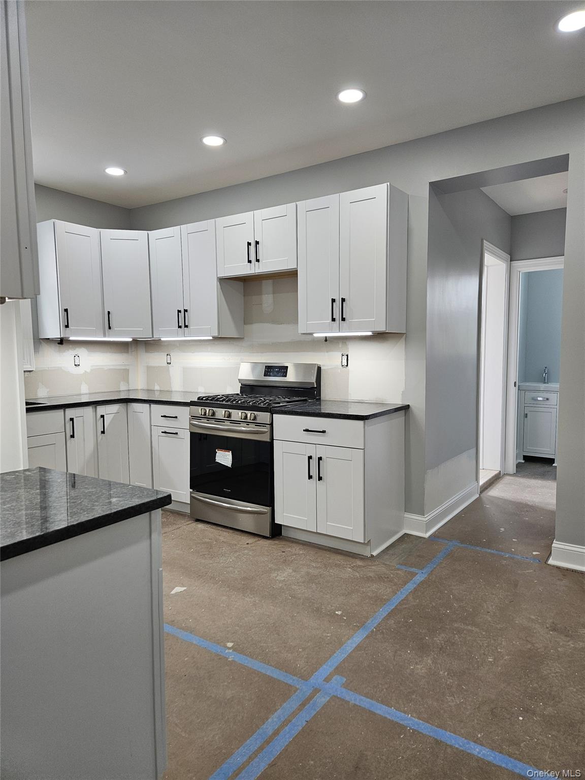 30-32 84th Street Queens, NY 11370 - Photo 9 of 37 a kitchen with stainless steel appliances granite countertop a stove a sink and a refrigerator