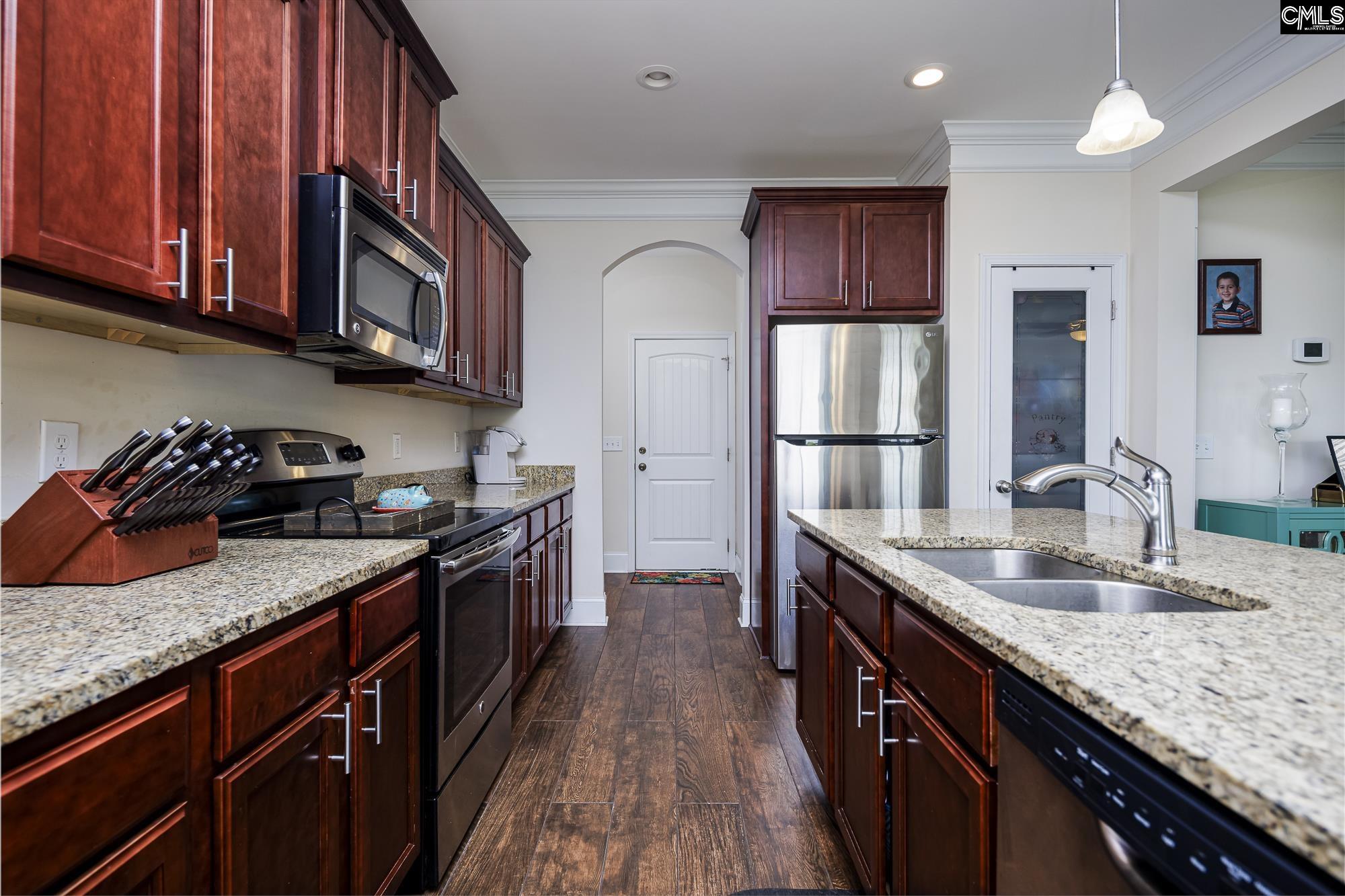 213 Sunset Point Drive Lexington, SC 29072 - Photo 11 of 35 a kitchen with stainless steel appliances granite countertop a stove sink and cabinets