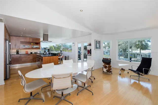a kitchen with stainless steel appliances a dining table and chairs