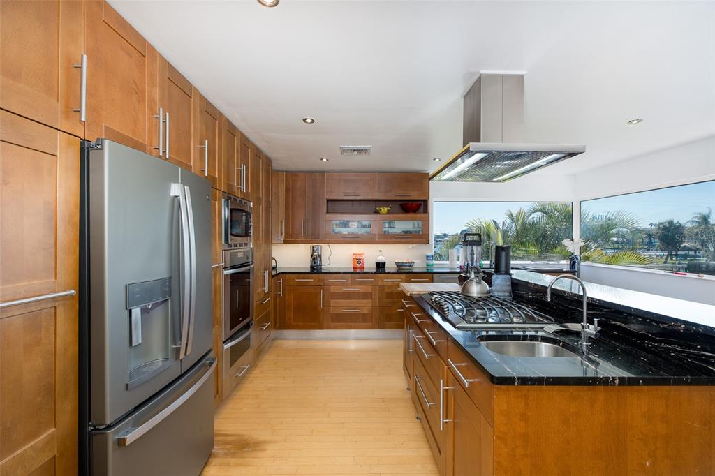 8401 Carolyn Drive Port Richey, FL 34668 - Photo 17 of 66 a large kitchen with stainless steel appliances granite countertop a sink and a refrigerator
